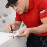 TECHNICIAN REPAIRING CHIPPED BATH